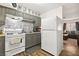 Modern kitchen showcasing grey cabinets, stainless steel appliances, and adjacent living area at 3982 Voxna St, Las Vegas, NV 89119