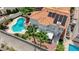 Aerial view of backyard with a sparkling pool, patio area, desert landscaping, and solar panels at 4 Tarryall Ter, Henderson, NV 89074