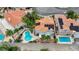 Aerial view of home with backyard pool, red tile roof, solar panels, desert landscaping, and privacy wall at 4 Tarryall Ter, Henderson, NV 89074