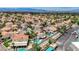 Areal community view with multiple homes, red tile roofs, swimming pools, and lush desert landscaping at 4 Tarryall Ter, Henderson, NV 89074