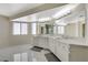 Bright bathroom with double vanity, marble countertops, and large mirrors at 4 Tarryall Ter, Henderson, NV 89074