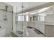 Modern bathroom with a glass enclosed shower, marble floors, and double sink vanities at 4 Tarryall Ter, Henderson, NV 89074