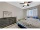 Comfortable bedroom featuring a ceiling fan, dresser and large picture frame at 4 Tarryall Ter, Henderson, NV 89074