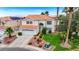 Two story stucco home with tile roof, lush lawn, mature trees and attached two car garage at 4 Tarryall Ter, Henderson, NV 89074