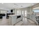 Modern kitchen featuring stainless steel appliances, quartz countertops, and an island with a built-in microwave oven at 4 Tarryall Ter, Henderson, NV 89074