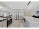 Modern kitchen with a large refrigerator and stainless steel stove featuring stone countertops and lots of cabinet space at 4 Tarryall Ter, Henderson, NV 89074