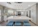 Bright, open kitchen featuring modern white cabinets, large island, stainless appliances and pendant lighting at 4 Tarryall Ter, Henderson, NV 89074