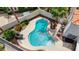Relaxing backyard with a kidney-shaped pool, lounge chairs, desert landscaping, and privacy fence at 4 Tarryall Ter, Henderson, NV 89074