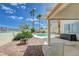 Backyard pool and patio with palm trees and blue skies at 4 Tarryall Ter, Henderson, NV 89074