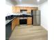 Bright kitchen featuring stainless steel appliances and stylish wood cabinetry at 4248 Tara Ave # 2, Las Vegas, NV 89102