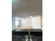 Bright kitchen with black countertops and stainless steel sink that overlooks the living room at 4248 Tara Ave # 2, Las Vegas, NV 89102