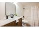 This bathroom features an oak vanity, white countertop, shower with curtain, and elegant black finishes at 427 Wright Way, Henderson, NV 89015