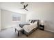 Relaxing bedroom features a ceiling fan, neutral carpet and a cozy gray bed at 427 Wright Way, Henderson, NV 89015