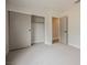 Cozy bedroom featuring neutral walls, plush carpet, and a closet with sliding doors at 427 Wright Way, Henderson, NV 89015