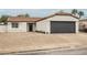 Charming single-story home with a low-maintenance front yard and attached two-car garage at 427 Wright Way, Henderson, NV 89015
