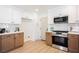 Updated kitchen featuring stainless steel appliances, tile backsplash and light wood-look floors at 427 Wright Way, Henderson, NV 89015