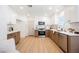 Modern kitchen boasts two-tone cabinets, stainless steel appliances, and gorgeous countertops at 427 Wright Way, Henderson, NV 89015