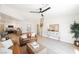 Spacious living room with stylish furniture, a large ceiling fan, and views into the kitchen at 427 Wright Way, Henderson, NV 89015