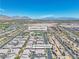 Aerial view featuring a community with modern homes, a community center with pool, and mountain views at 4277 Sunrise Flats St, Las Vegas, NV 89135