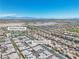 Aerial view featuring a community with modern homes, a community center with pool, and mountain views at 4277 Sunrise Flats St, Las Vegas, NV 89135