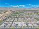 Wide aerial view showcases a community with modern homes and distant mountains in the Nevada landscape at 4277 Sunrise Flats St, Las Vegas, NV 89135