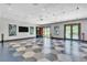 Spacious amenity room featuring modern lighting fixtures, geometric tile flooring, and access to the outdoors at 4277 Sunrise Flats St, Las Vegas, NV 89135