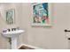 Chic powder room features pedestal sink, decorative mirror, and elegant wall art at 4277 Sunrise Flats St, Las Vegas, NV 89135