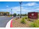 Inviting entrance to the Outlook Club, complemented by lush landscaping, palm trees and ample parking at 4277 Sunrise Flats St, Las Vegas, NV 89135
