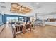 Bright common area with sofas, tables, a kitchen, and large windows overlooking the pool at 4277 Sunrise Flats St, Las Vegas, NV 89135