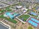 Aerial view of a community pool and recreation center, complete with pool, tennis courts, and lush lawns at 4277 Sunrise Flats St, Las Vegas, NV 89135