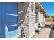 Welcoming front door with a stone accent wall and an inviting outdoor seating area at 4277 Sunrise Flats St, Las Vegas, NV 89135