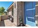 Close-up of the front door and sitting area featuring a unique stone accent and exterior design elements at 4277 Sunrise Flats St, Las Vegas, NV 89135