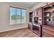 Cozy home office with built-in desk and shelving unit, bathed in natural light from the window at 4277 Sunrise Flats St, Las Vegas, NV 89135