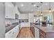 Modern kitchen boasts granite countertops, stainless steel appliances, and tiled backsplash at 4277 Sunrise Flats St, Las Vegas, NV 89135