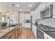 Well-equipped kitchen with stainless steel appliances, spacious counters, and wood tile flooring at 4277 Sunrise Flats St, Las Vegas, NV 89135