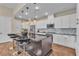 Modern kitchen features an island with bar seating, stainless steel appliances, and recessed lighting at 4277 Sunrise Flats St, Las Vegas, NV 89135