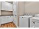 Bright laundry room with side-by-side washer and dryer, plus lots of storage in white cabinets at 4277 Sunrise Flats St, Las Vegas, NV 89135