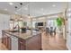 Open-concept living room with tile floors, dining area, and pendant lighting over the kitchen island at 4277 Sunrise Flats St, Las Vegas, NV 89135