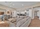 Bright and airy living room features a large sofa, recessed lighting, and wood tile flooring at 4277 Sunrise Flats St, Las Vegas, NV 89135