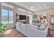 Open concept living room with large windows, and wood tile flooring at 4277 Sunrise Flats St, Las Vegas, NV 89135