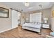 Spacious main bedroom features wood-look tile flooring and a slider barn door to the bathroom at 4277 Sunrise Flats St, Las Vegas, NV 89135