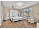 Bright main bedroom with wood-look tile flooring, and ample natural light from the window at 4277 Sunrise Flats St, Las Vegas, NV 89135