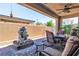 Covered patio with stone water feature and comfortable seating area, perfect for relaxation at 4277 Sunrise Flats St, Las Vegas, NV 89135