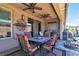 Cozy covered patio featuring ceiling fans, stone flooring, a modern wall art piece, a grill, and a tranquil water feature at 4277 Sunrise Flats St, Las Vegas, NV 89135