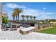 Inviting pool area with lounge seating, a fire pit, palm trees, and well-maintained landscaping at 4277 Sunrise Flats St, Las Vegas, NV 89135