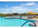 Large community pool surrounded by lounge chairs, tables, and umbrellas for ultimate relaxation at 4277 Sunrise Flats St, Las Vegas, NV 89135