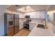 Modern kitchen featuring white cabinets, subway tile backsplash, stainless steel appliances, and quartz countertops at 5040 Spencer St # D, Las Vegas, NV 89119