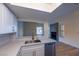 Well-lit kitchen with white cabinets, subway tile, quartz counters, stainless dishwasher and an open layout at 5040 Spencer St # D, Las Vegas, NV 89119