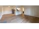 Spacious living room with wood-look flooring, open to the kitchen and bathroom at 5040 Spencer St # D, Las Vegas, NV 89119
