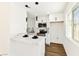 Modern kitchen featuring white cabinets, marble countertops, stainless steel appliances, and a stylish pendant lights at 5078 Mountain Vista St, Las Vegas, NV 89120
